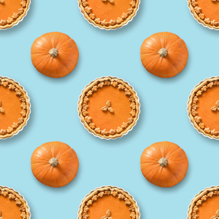 Seamless pattern of traditional American pumpkin pie and pumpkins on blue background.の写真素材