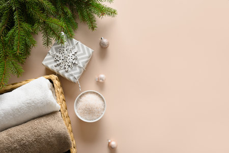 Winter body care and Christmas Spa concept with gift, cosmetic sea salt on beige background. View from above. Special offer for beauty services. Copy space. View from above.の写真素材