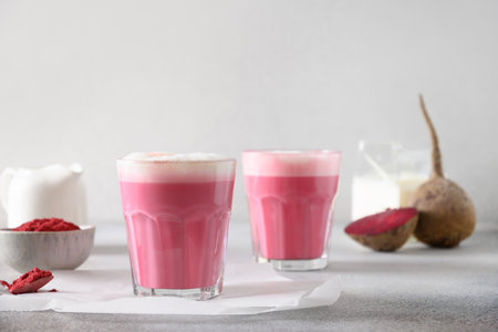 Beetroot latte of beetroot powder and vegan milk on gray background. Great warming drink.の写真素材