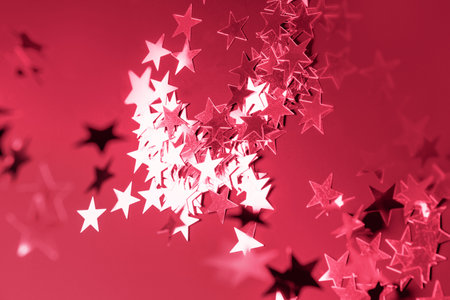 Shiny viva magenta stars glitter or confetti. Festive holiday backdrop and pattern. Via magenta color trendy 2023 background.の写真素材