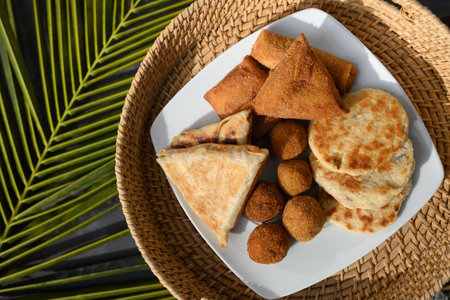 Authentic Sri Lankan different street food, short eats. Vegetable roti, coconut roti, cutlets, mutton rolls on white plate. View from above. Copy space.の写真素材