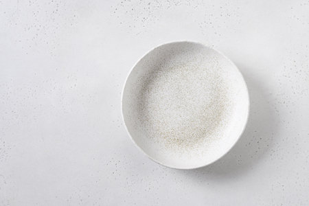 White empty plate on white culinary background. Kitchen and cooking template, mock up. View from above.の写真素材