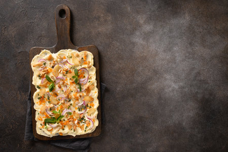 Homemade viral trendy Butterboard with onion, garlic, orange, herbs, crispy baguette and toasts on dark background. View from above. Copy space.の写真素材