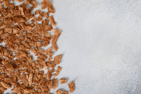Coconut chips with cinnamon on gray background with copy space. View from above.の写真素材