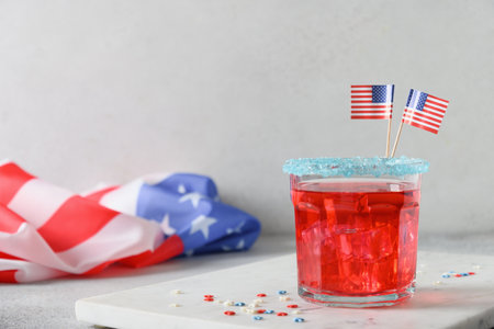 Patriotic red pomegranate margarita cocktail on white background. Rim your festive beverages in blue sugar for popping for July 4th. Close up. Copy space.の写真素材