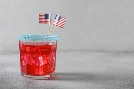 Patriotic red pomegranate margarita cocktail on gray background. Festive beverage for American Independence Day. Close up. Copy space. Rimmed drinks.の写真素材
