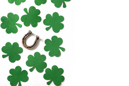 St. Patrick's day banner with clover leaves and horseshoe on white background. Space for text. Flat lay. View from above.の写真素材
