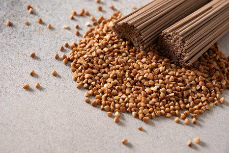 Uncooked buckwheat noodles soba on gray background. Space for text. Healthy vegan diet. Close up. Alternative gluten free pasta.の写真素材