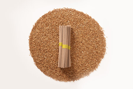 Raw buckwheat noodles soba in bundle on white background. Healthy vegan diet. Alternative gluten free pasta. Organic food.の写真素材