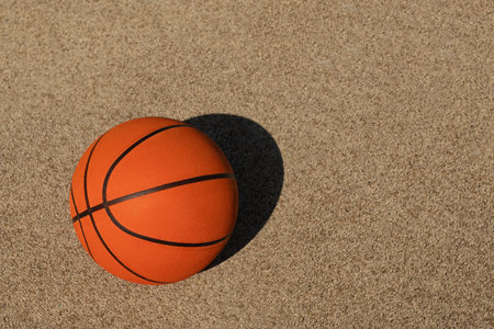 Basketball orange ball on sport field. Sports gear without people. Sport background. Team sport. Copy space. View from aboveの写真素材