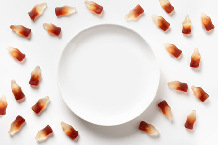 Gummy jellies and white empty plate with space for text on white background. View from above.の写真素材