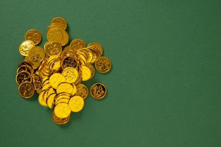 St Patricks day concept with golden coins on green background. View from above. Copy space. Festive celebration.の写真素材