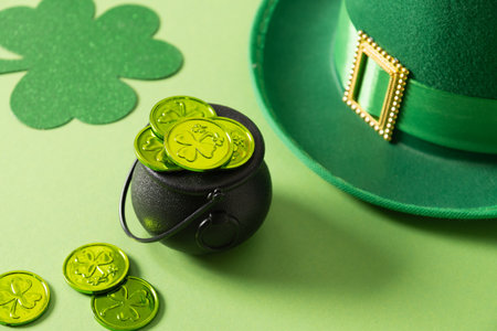 St Patricks day and March 17 concept of parade Leprechaun Hat with belt and green coins in black pot...