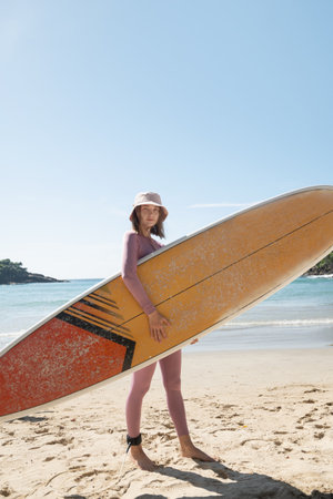 Attractive woman surfer going to surfing. Surfing of woman at beach with surfboard for freedom....