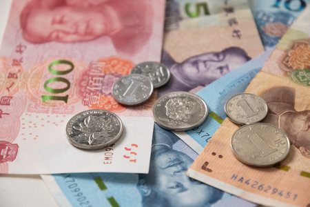 Many of different Chinese yuan banknotes. Chinese paper currency Yuan renminbi banknotes and coins...