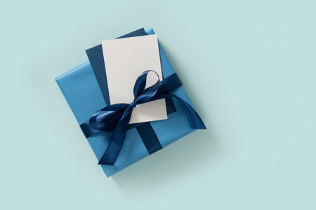 Happy Fathers Day gift box and blank on pastel blue background. Flat lay. View from above. Copy space.の写真素材