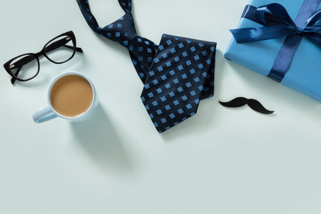 Happy Fathers Day frame. Greeting card with gift, coffee cup, necktie, glasses on blue background....
