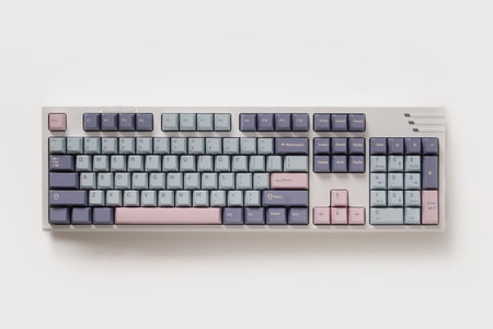 Mechanical pastel colored keyboard on white background. Minimal style and design keyboard. Custom build keyboard. Colorful key pastel pink and gray cap. Top view.の写真素材