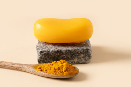 Handmade turmeric soap on stone. Organic skincare product perfect for wellness, beauty, and organic body care concepts. Close up.の写真素材