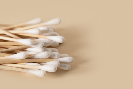 Wooden ecological cotton swab on beige background. Zero waste, sustainable resources. Close up.の写真素材