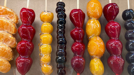 Chinese dessert Tanghulu made from crunchy caramelized fruit on a skewer. Sweet street foodの写真素材