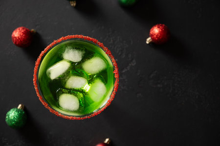 Xmas Green Punch in glass decorated sugar rim on white table make of cool lime sherbet. Festive drink for Christmas holiday. View from above.の写真素材