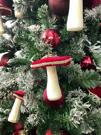 Christmas decorated store with decorative mushrooms and twinkling lights garland. Xmas holiday background. Festive winter trendy exterior for luxury storeの写真素材