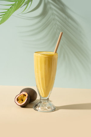 Passion Fruit Lassi with summer shadow. Vertical format. Indian healthy beverage lassi made of yogurt, water, spices, fruits and ice.の写真素材