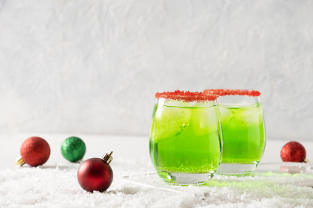 Xmas Green Punch Cocktails decorated sugar rim on white make of cool lime sherbet. Tasty drink for Christmas holiday. Rim your festive beverages in red sugar.の写真素材