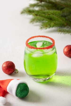 Xmas Green Punch or Cocktail decorated red sugar rim on white background make of cool lime sherbet. Tasty drink for Christmas holiday.の写真素材