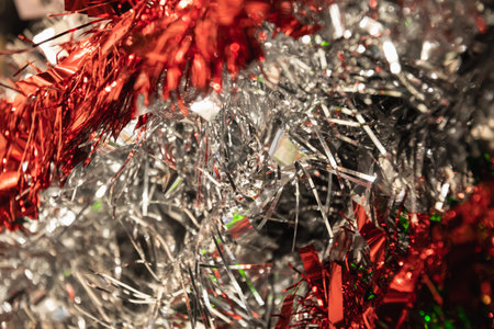 Colorful silver and red tinsel Christmas tree bokeh background. Festive pattern. Xmas holiday spirit.の写真素材