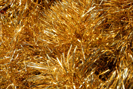 Golden tinsel Christmas tree bokeh background. Festive pattern. Xmas holiday spirit.