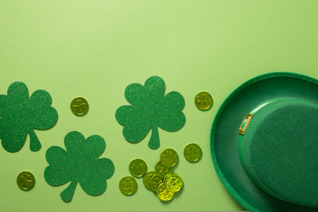 St Patricks day and March 17 frame with leprechaun hat and clover leaves on green background. View...