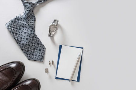 Tie, watch, shoes, cufflinks and card arranged on light background. Fathers Day concept. Business...