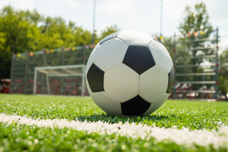 Soccer ball on field near goal net football match concept