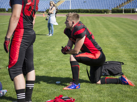 Teams for American football against the backdrop of a green field. Playing American football at the stadium. Match on American football. Men play the ball in a sports stadium.のeditorial素材