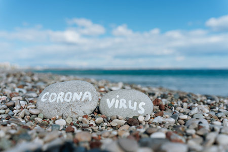stones on the beach with a blue sea and the inscriptionの写真素材