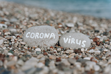 stones on the beach with a blue sea and the inscriptionの写真素材