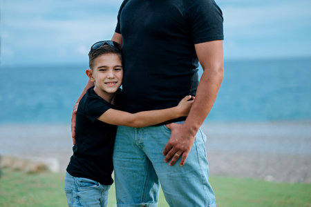 Son holding father. Concept of happy family and of summer vacationの写真素材