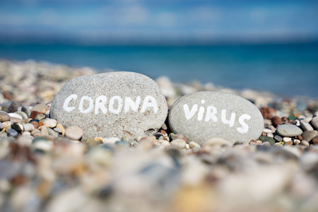 stones on the beach with a blue sea and the inscriptionの写真素材