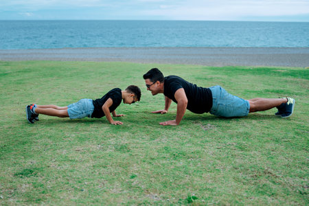 Father and son playing and having fun doing sport together. Concept of happy family and of summer vacationの写真素材