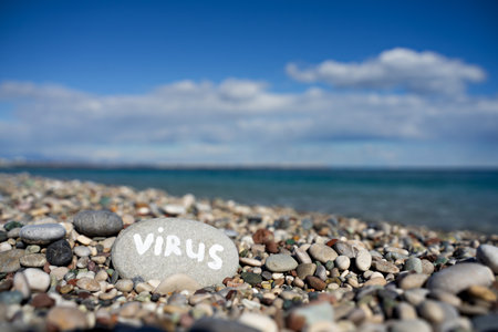 stones on the beach with a blue sea and the inscriptionの写真素材
