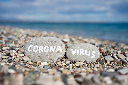 stones on the beach with a blue sea and the inscriptionの写真素材