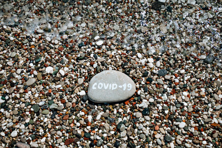 Stones on the beach with a blue seaの写真素材