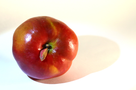 A large red ripe appetizing apple with a leaf.の写真素材
