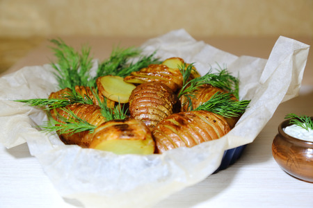 Baked, fried potatoes with fresh dill and sour cream sauce.