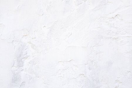Abstract empty light white construction background with texture of stucco building material on the surface of a rustic vintage kitchen wall with copy spaceの写真素材