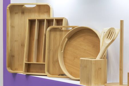 Wooden dishes. Kitchen utensils and accessories made of bamboo. Eco-friendly products. Various salad...