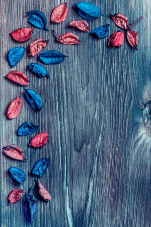 Beautiful bright original elegant floral wooden background flatlay with multicolored blue and pink red dried flowers with copy space for your holiday greeting textの写真素材