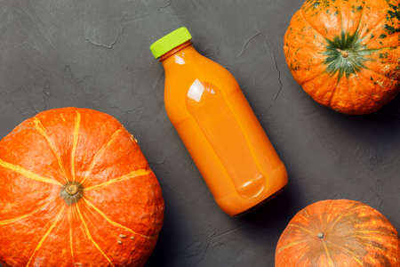 Healthy Diet Vitamin Vegetarian Food for Breakfast, Cholesterol Removing Pumpkin Juice, Natural Vegetable Fruit Orange Drink containing Potassium Carnitine in glass Bottle Table top viewの写真素材